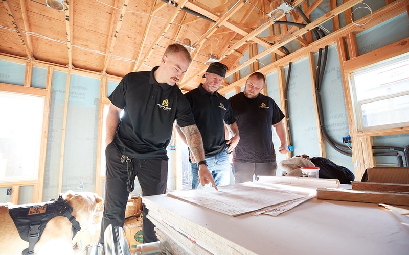Anchored Tiny Homes workers inside a construction project.