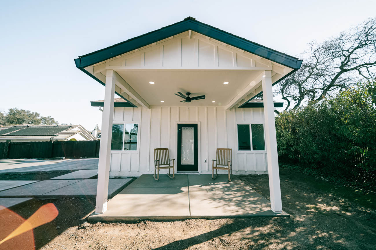 Anchored Tiny Homes Houston / Memorial in front of a white ADU, done by our garage contractor in Houston, TX.